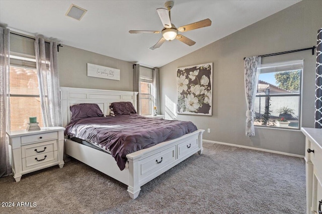 bedroom with carpet, ceiling fan, lofted ceiling, and multiple windows