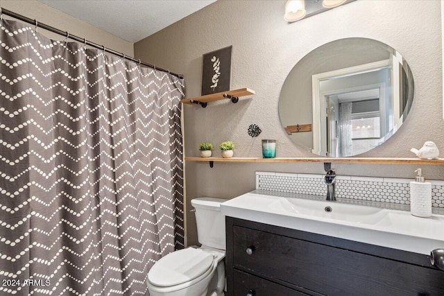 bathroom featuring a shower with curtain, vanity, a textured ceiling, and toilet