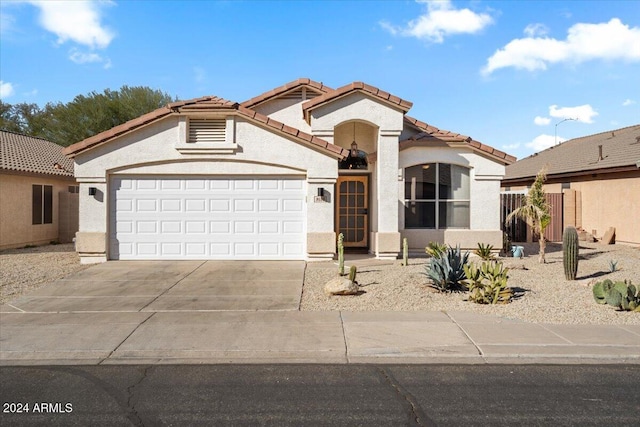 mediterranean / spanish-style house with a garage