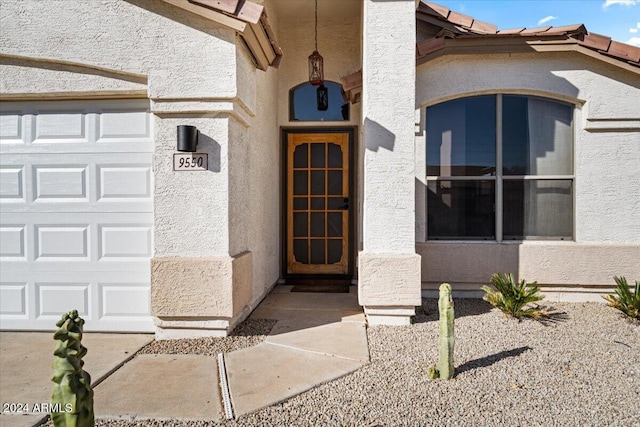 doorway to property with a garage