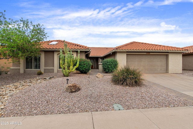 2461 Leisure World, Mesa, AZ 85206 - mediterranean / spanish home featuring concrete driveway, stucco siding, an attached garage, and a tile roof