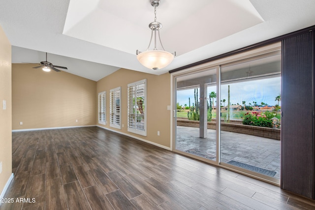 2461 Leisure World, Mesa, AZ 85206 - spare room with baseboards, dark wood-style flooring, a ceiling fan, a tray ceiling, and vaulted ceiling