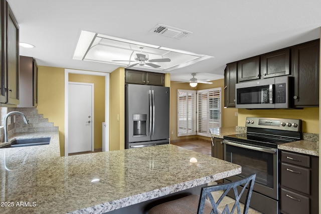 2461 Leisure World, Mesa, AZ 85206 - kitchen with a peninsula, a ceiling fan, visible vents, appliances with stainless steel finishes, and a sink