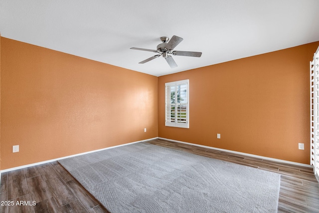 2461 Leisure World, Mesa, AZ 85206 - empty room with wood finished floors, baseboards, and a ceiling fan