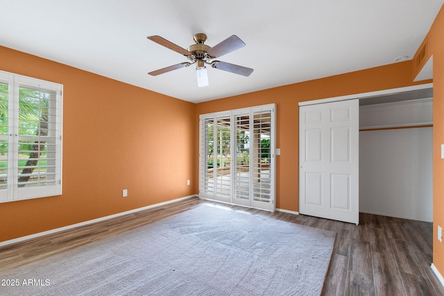 2461 Leisure World, Mesa, AZ 85206 - unfurnished bedroom with multiple windows, access to exterior, and wood finished floors