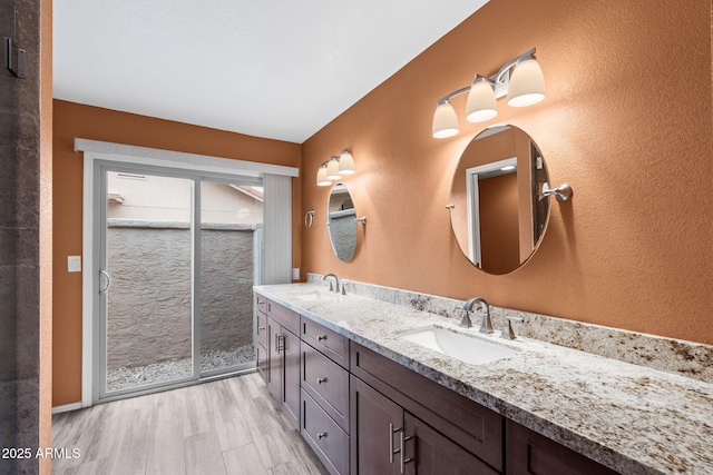 2461 Leisure World, Mesa, AZ 85206 - full bathroom featuring a shower stall, double vanity, a sink, and wood finished floors