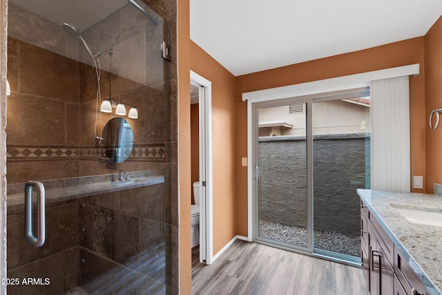 2461 Leisure World, Mesa, AZ 85206 - bathroom with toilet, a shower stall, vanity, and wood finished floors