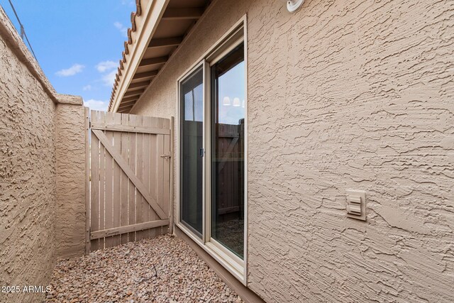 2461 Leisure World, Mesa, AZ 85206 - view of home's exterior featuring fence, a gate, and stucco siding