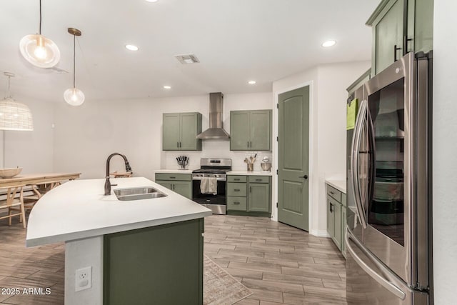 11541 E Corbin Ave, Mesa, AZ 85212 - kitchen featuring green cabinets, appliances with stainless steel finishes, wall chimney exhaust hood, a sink, and light countertops