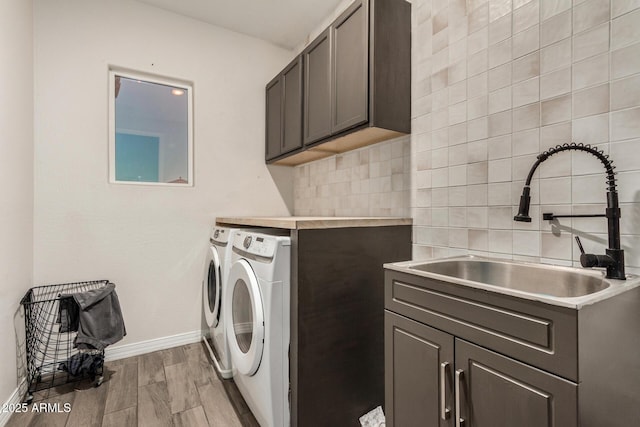 11541 E Corbin Ave, Mesa, AZ 85212 - laundry room featuring cabinet space, independent washer and dryer, baseboards, and light wood-style floors
