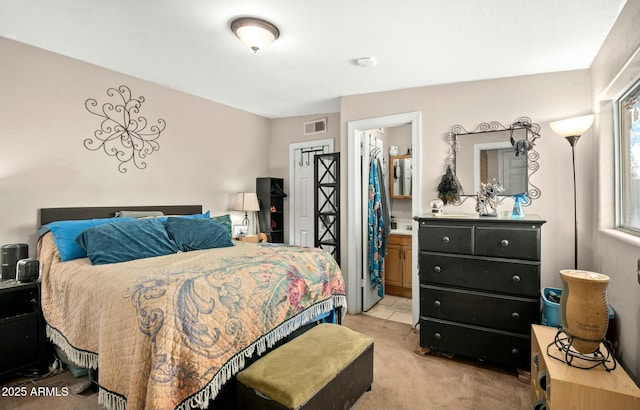 bedroom with ensuite bath, visible vents, and light colored carpet