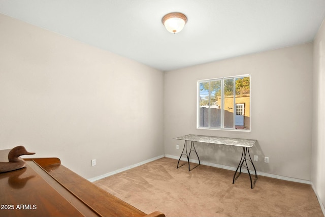 office area with light carpet and baseboards