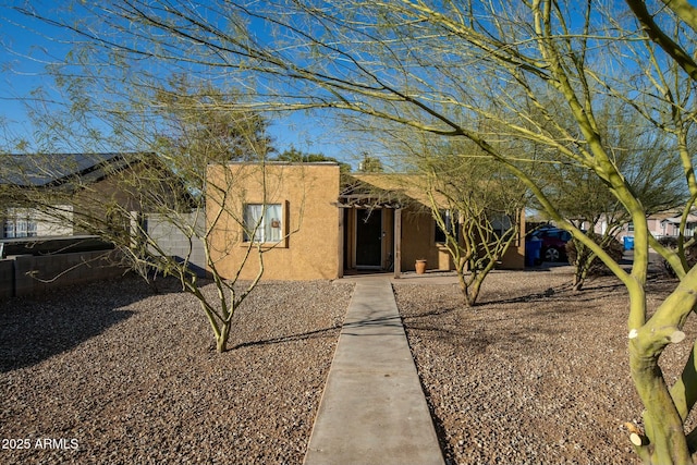 pueblo-style home with stucco siding