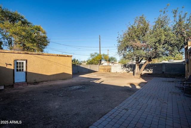 view of yard with a fenced backyard and a patio