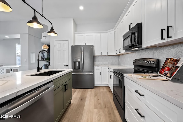 kitchen featuring a sink, light stone countertops, black appliances, and white cabinets