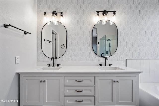 full bath with double vanity, a bath, and a sink