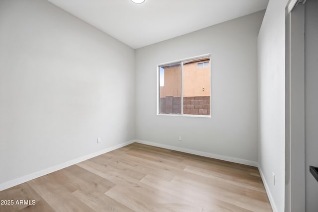 unfurnished room featuring light wood-style flooring and baseboards