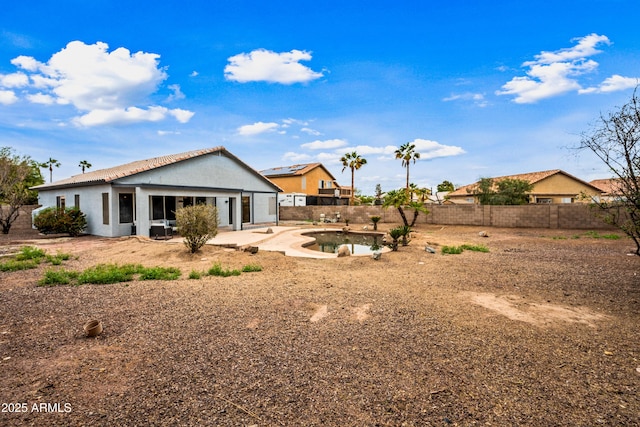 back of property with a patio, a tiled roof, a fenced backyard, and stucco siding