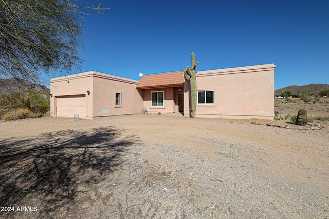 back of property featuring a garage