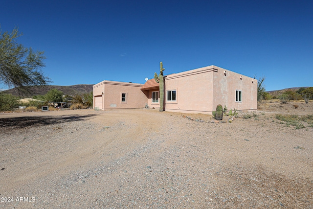 back of house with a mountain view