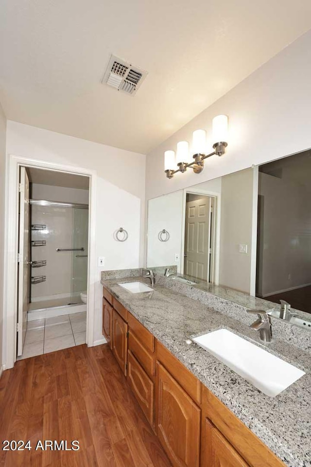 bathroom with vanity, hardwood / wood-style flooring, toilet, and an enclosed shower