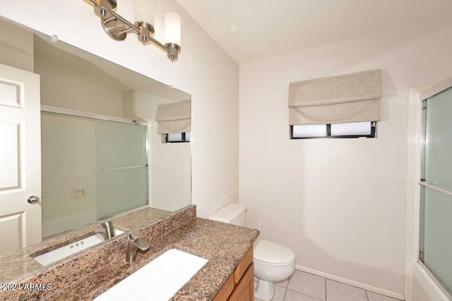 full bathroom featuring tile patterned floors, shower / bath combination with glass door, vanity, and toilet