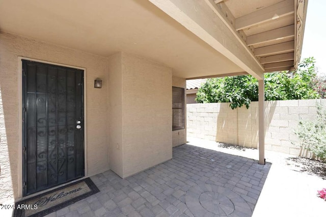 property entrance featuring a patio