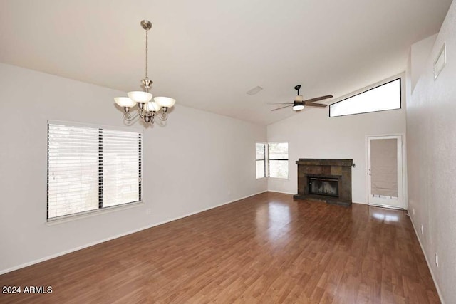 unfurnished living room featuring ceiling fan with notable chandelier, dark hardwood / wood-style flooring, and vaulted ceiling