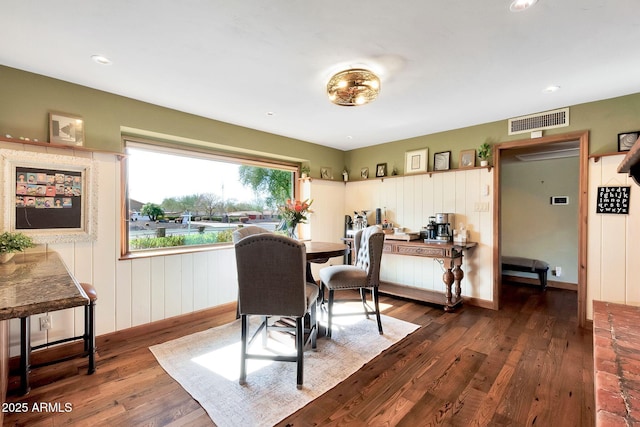 dining space with dark hardwood / wood-style flooring