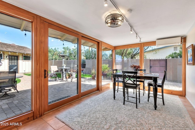 sunroom with rail lighting and an AC wall unit