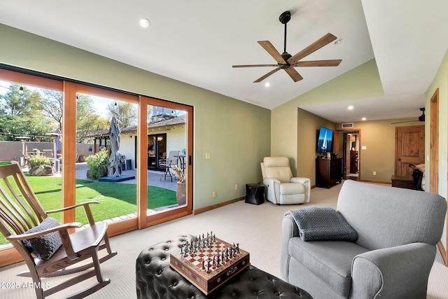 living room featuring lofted ceiling, carpet floors, and ceiling fan