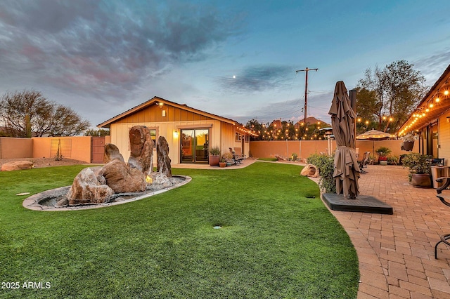 yard at dusk with a patio