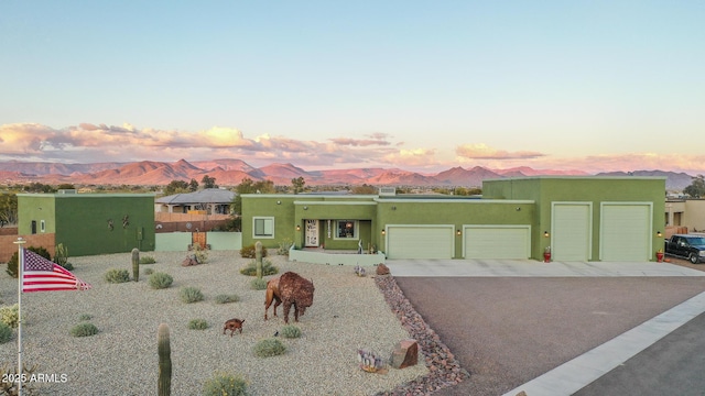 view of front of house featuring a garage and a mountain view