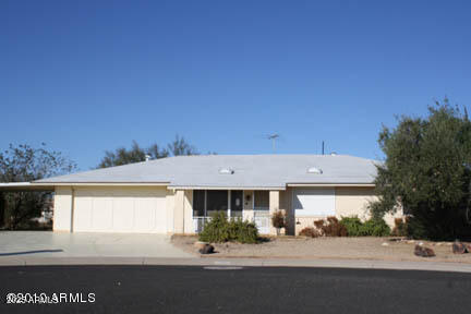 9826 W Santa Fe Dr, Sun City, AZ 85351 - ranch-style home featuring concrete driveway, an attached carport, and an attached garage