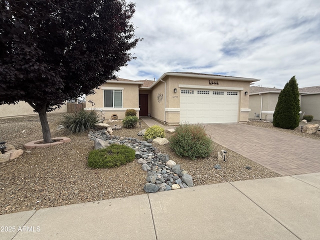 12945 E Vega St E, Dewey, AZ 86327 - view of front of property with a garage, decorative driveway, and stucco siding