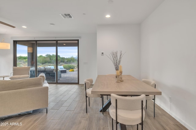 dining room featuring visible vents, baseboards, recessed lighting, and wood finished floors