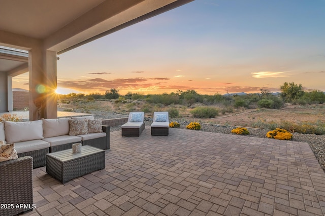 patio terrace at dusk featuring outdoor lounge area