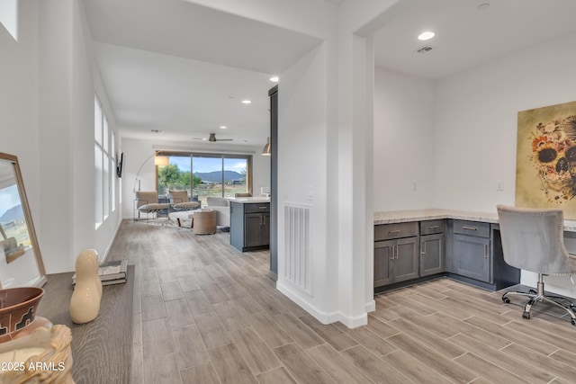 office space featuring recessed lighting, visible vents, light wood-type flooring, and ceiling fan