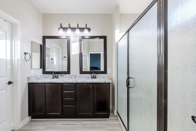 bathroom with vanity, hardwood / wood-style floors, and walk in shower