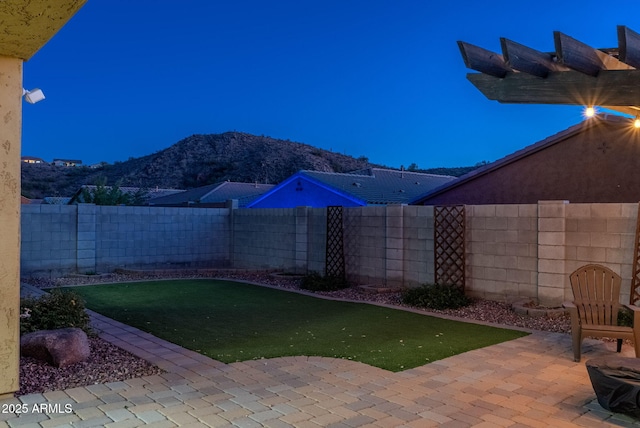 view of yard featuring a mountain view and a patio