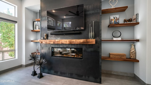 details with a fireplace, baseboards, and wood finished floors