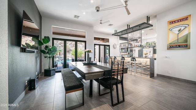 dining space with a ceiling fan, french doors, visible vents, and baseboards