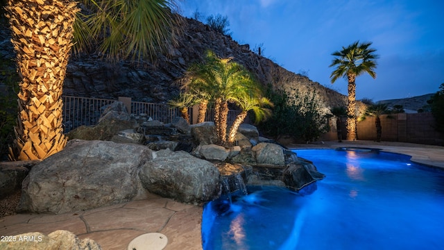 view of pool with a fenced backyard, a mountain view, and a fenced in pool