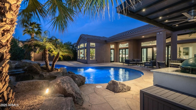 outdoor pool featuring a patio area and an outdoor living space