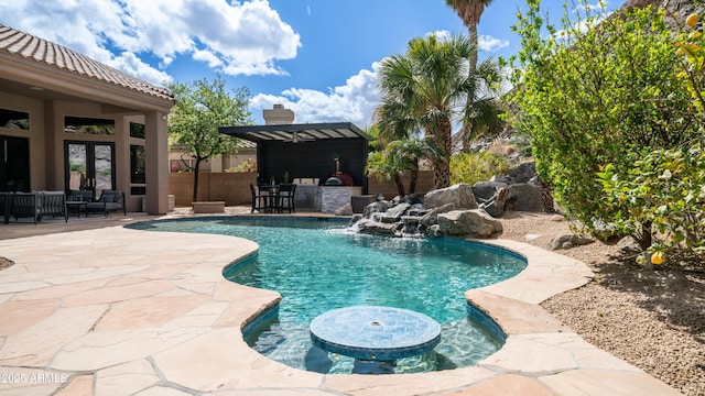 view of swimming pool with a patio, outdoor dry bar, french doors, a fenced in pool, and a pergola