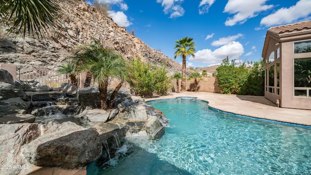 view of pool featuring a mountain view, a patio area, a fenced backyard, and a fenced in pool