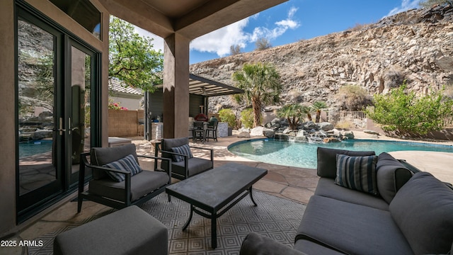 view of swimming pool with a fenced in pool, a patio, fence, a mountain view, and an outdoor living space