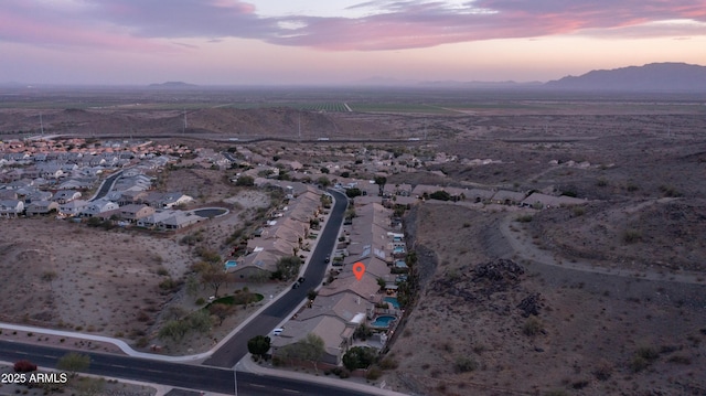 aerial view at dusk featuring a residential view and a mountain view