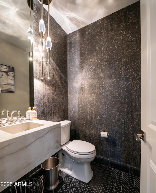 bathroom with a sink, tile patterned flooring, and toilet