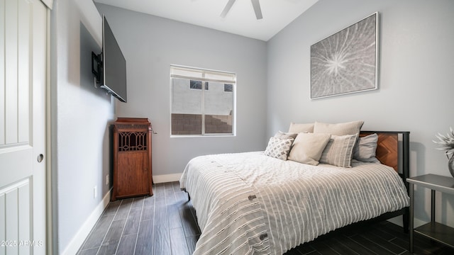 bedroom with ceiling fan, baseboards, and wood finished floors